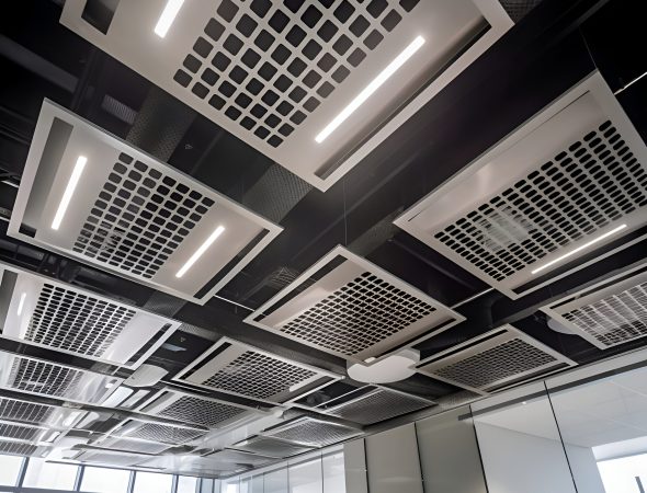 Interior of a modern office building with ceiling lights and ventilation pipes